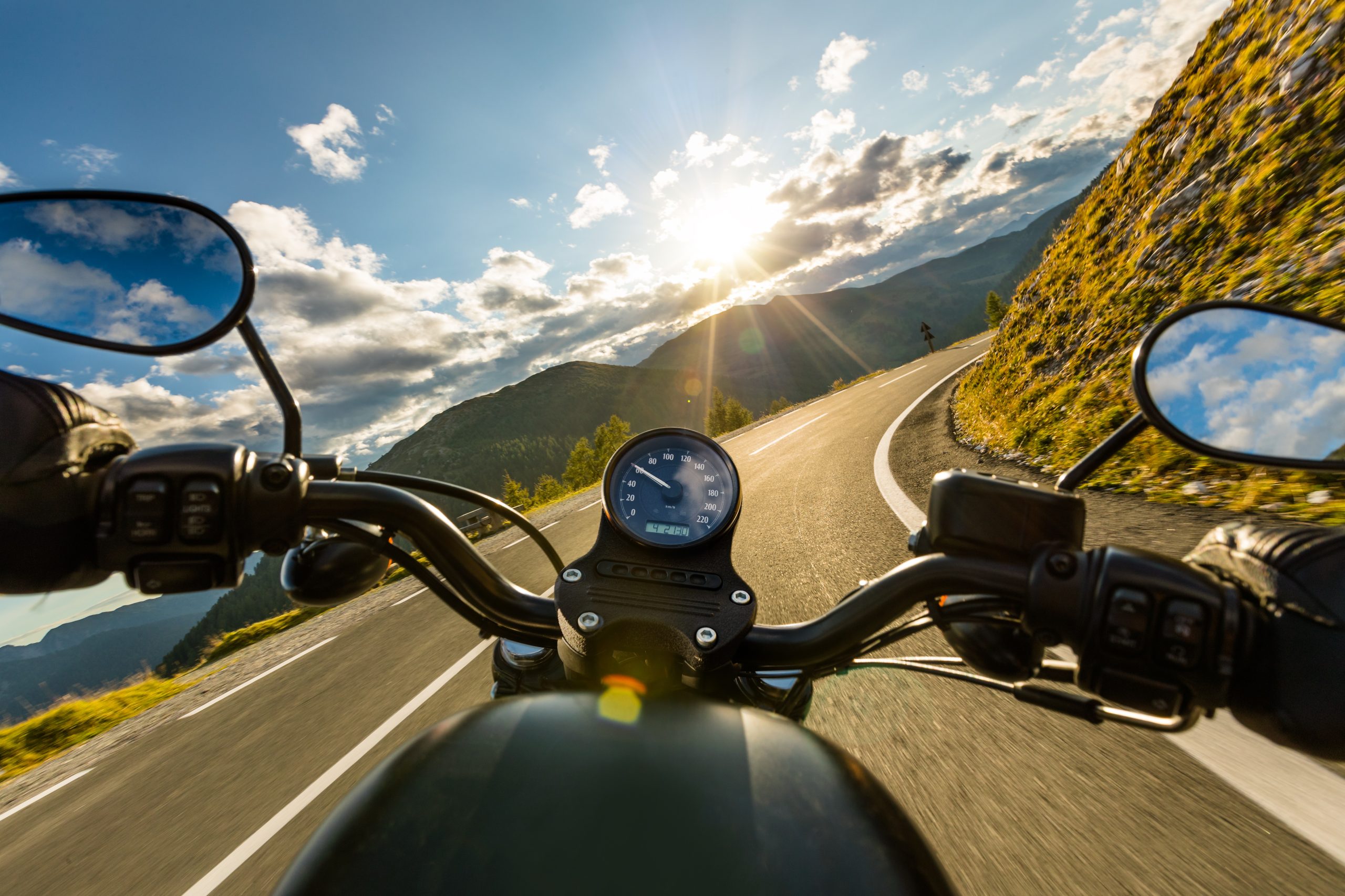 Motorcyclist riding down a mountain pass